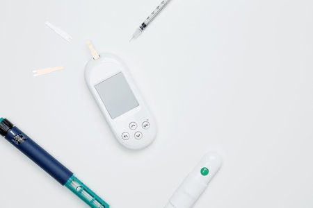Diabetes concept with glucometer, syringe pen with insulin, blood test strips. Concept of worldwide...