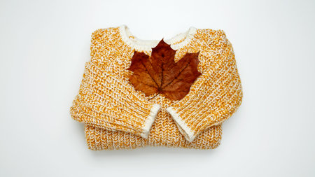 Autumn clothing. Warm golden sweater. Top view