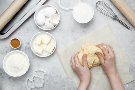Making different shapes of fall cookies for Halloween. Woman rolling out dough