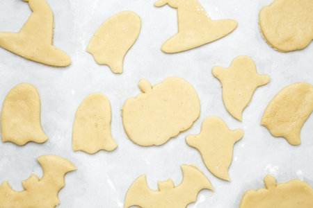 Making different shapes of fall cookies for Halloween. Dough with cookie cutterの写真素材