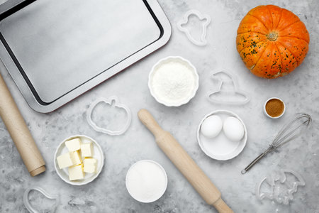 Ingredients for baking Halloween cookies including flour, butter, sugar, spices, eggs and pumpkin. Seasonal autumn bakingの写真素材
