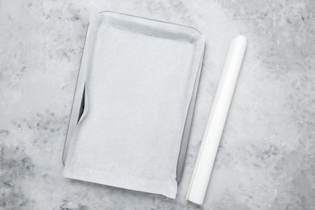 Empty baking tray covered with baking paperの写真素材