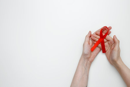 Woman holding red AIDS awareness ribbon. World AIDS Dayの写真素材