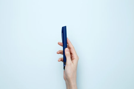 Woman hands holding syringe pen with insulin. Concept of worldwide diabetes awareness