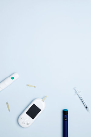 Diabetes concept with glucometer, syringe pen with insulin, blood test strips. Concept of worldwide diabetes awareness. Top view. Copy spaceの写真素材