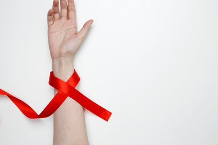Woman holding red AIDS awareness ribbon. World AIDS Day