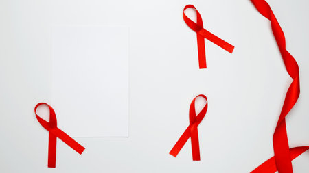 World AIDS Day. Red ribbon with awareness about AIDS and paper for mock upの写真素材