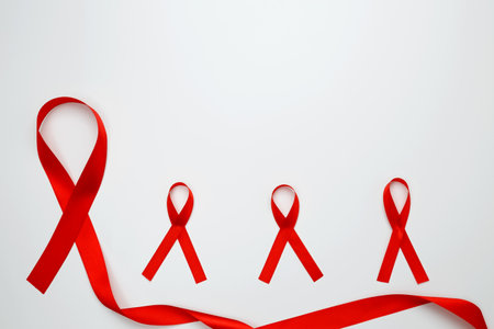 Red ribbons with awareness about AIDS on a white background. World AIDS Dayの写真素材