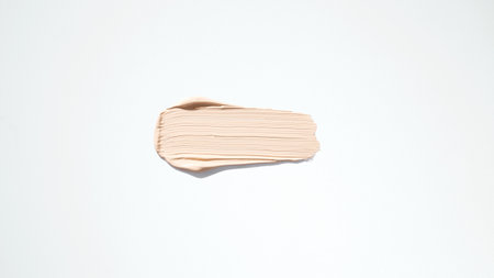 Cosmetic makeup cream sample isolated on white. Liquid foundation smudge. Beauty skincare texture...