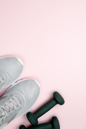Fitness equipment set with dumbbells and athletic shoesの写真素材