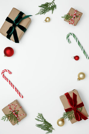 Creating a festive, natural holiday scene wrapped Christmas gifts with green thuja branchesの写真素材