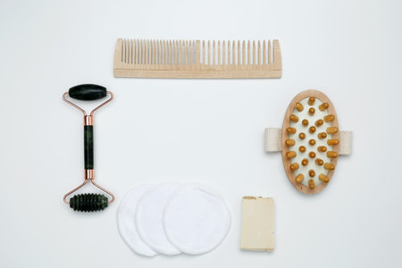 Eco-friendly beauty essentials, including soap, bamboo toothbrush, loofah sponge, marble face...