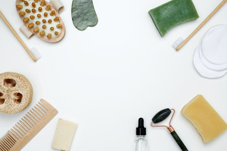 Eco-friendly beauty essentials, including soap, bamboo toothbrush, loofah sponge, marble face...