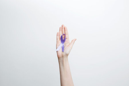 Purple Epilepsy Awareness Day, purple ribbon held, symbol of supportの写真素材