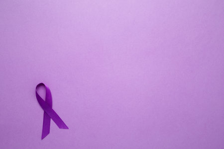 Purple Epilepsy Awareness Day, purple ribbon held, symbol of support