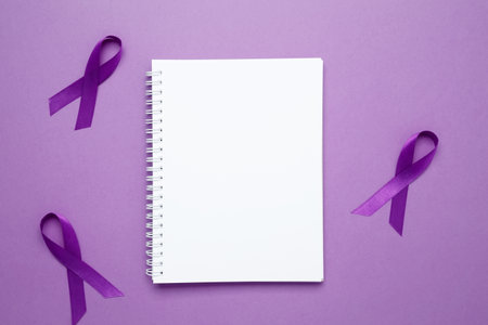 Purple Epilepsy Awareness Day, purple ribbon held, symbol of support. Mock up notebookの写真素材