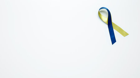 Symbolizing World Down Syndrome Day. A yellow and blue awareness ribbonの写真素材