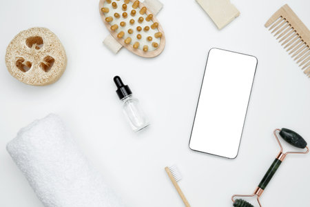 Mockup for beauty and wellness design. Smartphone with blank white screen surrounded by natural skincare and self-care productsの写真素材