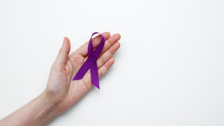 Purple ribbon held, symbol of support. Purple Epilepsy Awareness Dayの写真素材