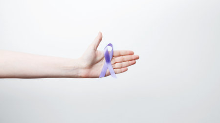 Purple ribbon held, symbol of support. Purple Epilepsy Awareness Dayの写真素材