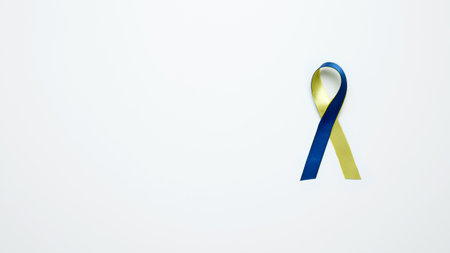 Symbolizing World Down Syndrome Day. A yellow and blue awareness ribbonの写真素材