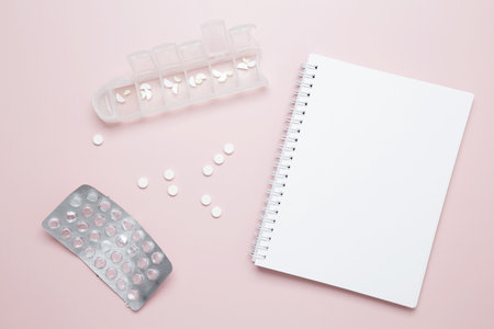 Blister of tablets and blank notebook. Concept of medicine, healthcare, and pharmaceutical industryの写真素材