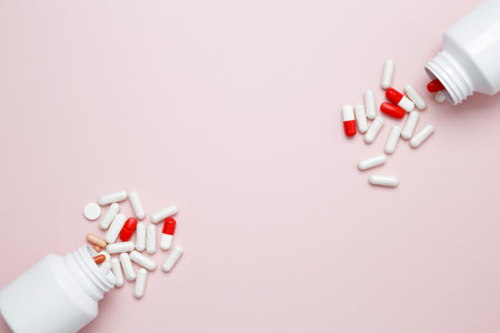 White bottles container with colorful medication capsules and tablets. Concept of healthcare and medicineの写真素材