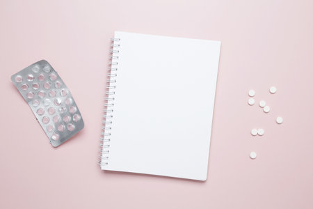 Blister of tablets and blank notebook. Concept of medicine, healthcare, and pharmaceutical industryの写真素材