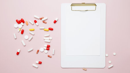 Concept of medicine, healthcare, pharmaceutical industry. Blister of tablets and blank clipboardの写真素材