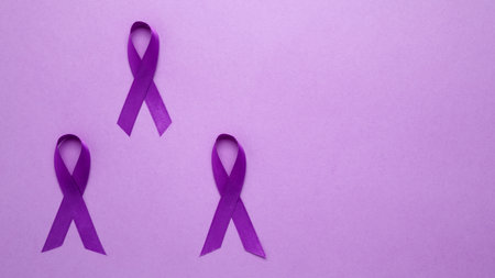 Purple ribbon held, symbol of support. Purple Epilepsy Awareness Dayの写真素材