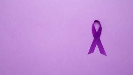 Purple ribbon held, symbol of support. Purple Epilepsy Awareness Dayの写真素材