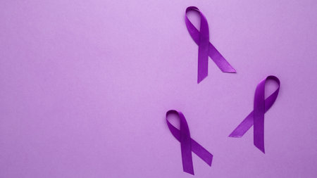 Purple ribbon held, symbol of support. Purple Epilepsy Awareness Dayの写真素材