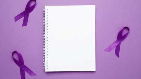 Purple Epilepsy Awareness Day, purple ribbon held, symbol of support. Mock up notebookの写真素材