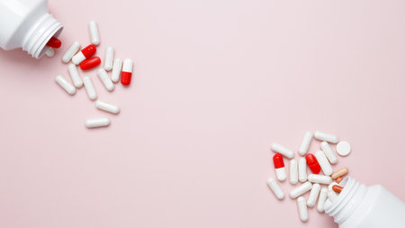 White bottles container with colorful medication capsules and tablets. Concept of healthcare and medicineの写真素材