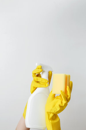 Household cleaning and hygiene concept. Womans hand in holds pink dishwashing sponge and cleaning...