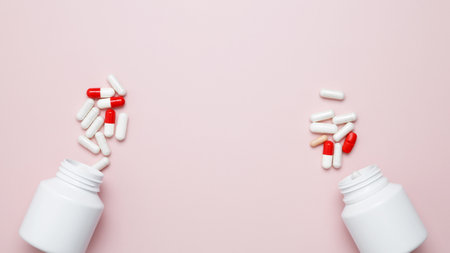White bottles container with colorful medication capsules and tablets. Concept of healthcare and medicineの写真素材