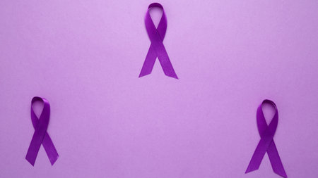 Purple ribbon held, symbol of support. Purple Epilepsy Awareness Dayの写真素材