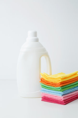 Laundry detergent branding mock up and clean stack of colorful towels. Household cleaning and hygiene concept packagingの写真素材