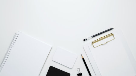 Monochrome stationery items. On a white background, an empty mock up notebook and clipboard, white and black cardsの写真素材