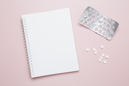 Blister of tablets and blank notebook. Concept of medicine, healthcare, and pharmaceutical industry