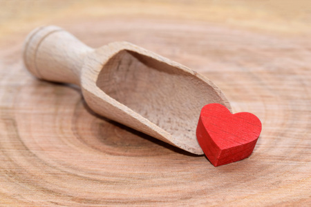 Wooden decoration with red heart on cherry wood backgroundの写真素材