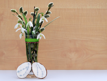 Spring composition with snowdrops, willow twigs and gingerbread eggsの写真素材