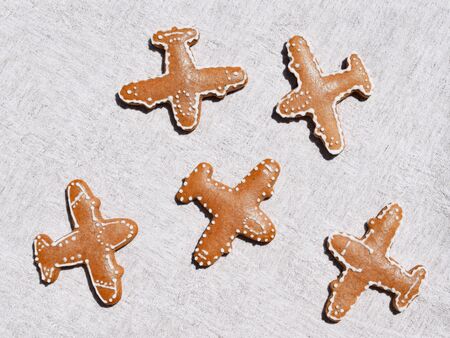 Gingerbreads in a shape of airplane on a light backgroundの写真素材