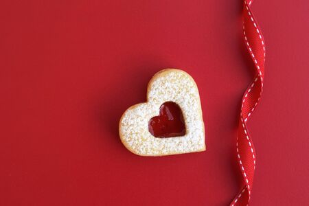 Love concept - linzer heart with ribbon on red backgroundの写真素材