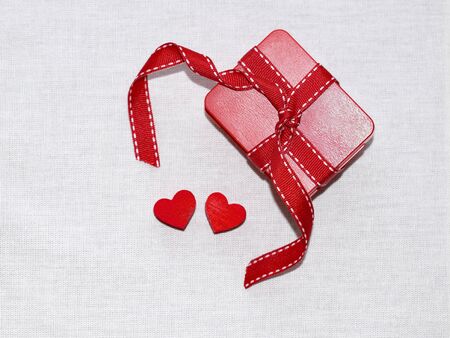 Gift box with ribbon and two hearts - valentineÂ´s day, love concept