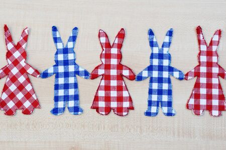Homemade fabric bunnies holding hands - creative hobby in spring or Easter time