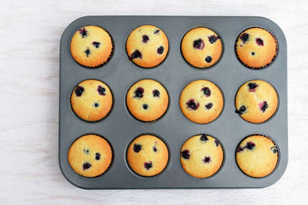 Summer baking - delicious homemade muffins with black currant, just pulled out of the oven