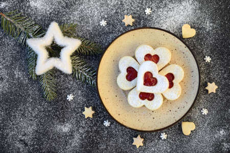Heart shaped linzer cookies filled with strawberry jam, with romantic festive Christmas decoration
