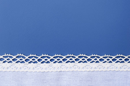 Festive romantic blue background with white lacy border, copy space for textの写真素材