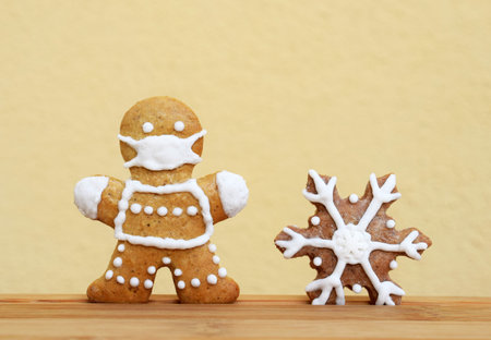 Gingerbreads decorated with white icing - man with protective face mask and snowflake. Original...